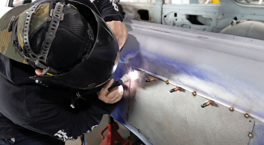 TIG welder precisely fuses the patch panel to the quarter panel for a seamless repair on the 1966 Chevelle wagon