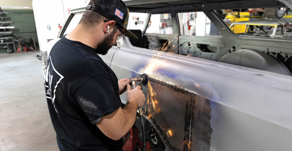die grinder removes excess weld material, preparing the surface for final smoothing and blending