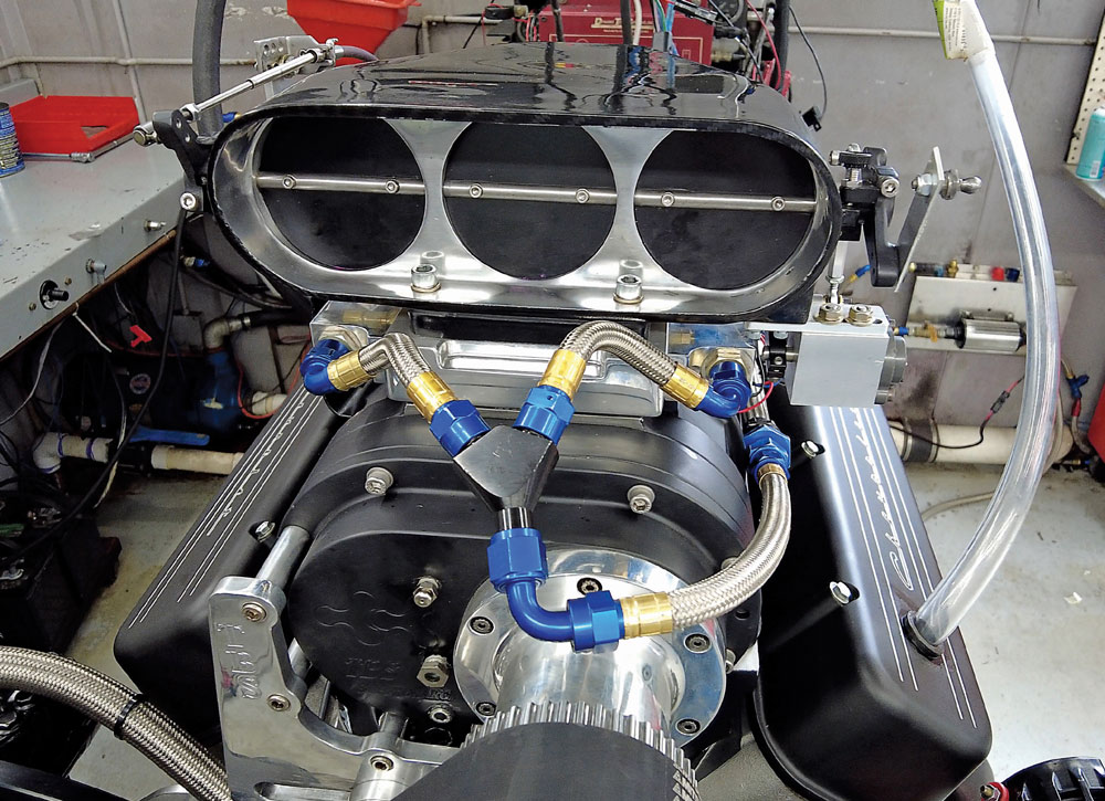 Close-up supercharged big block Chevy triple throttle intake fuel injection race-ready setup