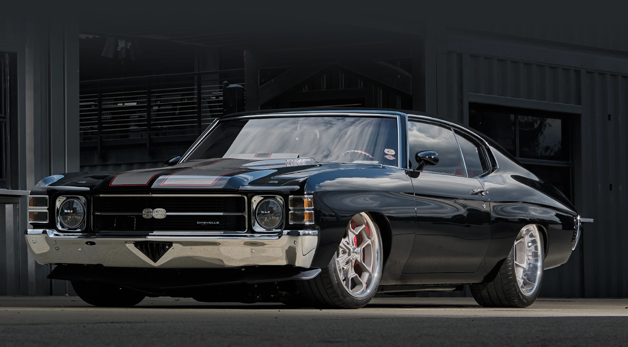 1971 Chevrolet Chevelle SS parked in an industrial setting, highlighting its lowered suspension and wide wheels