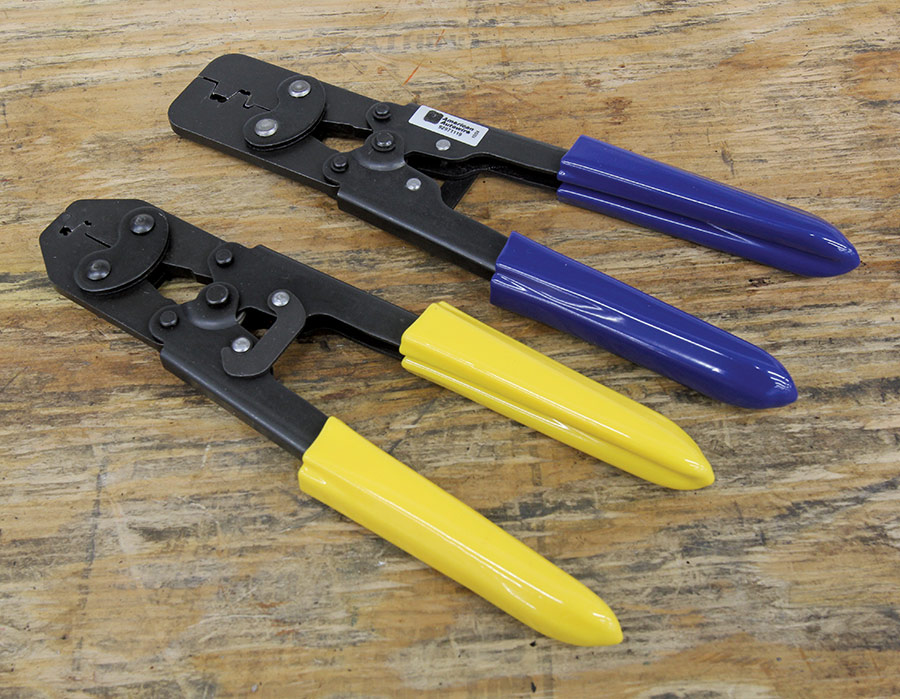 Pair of professional-grade crimping tools with yellow and blue handles for electrical work