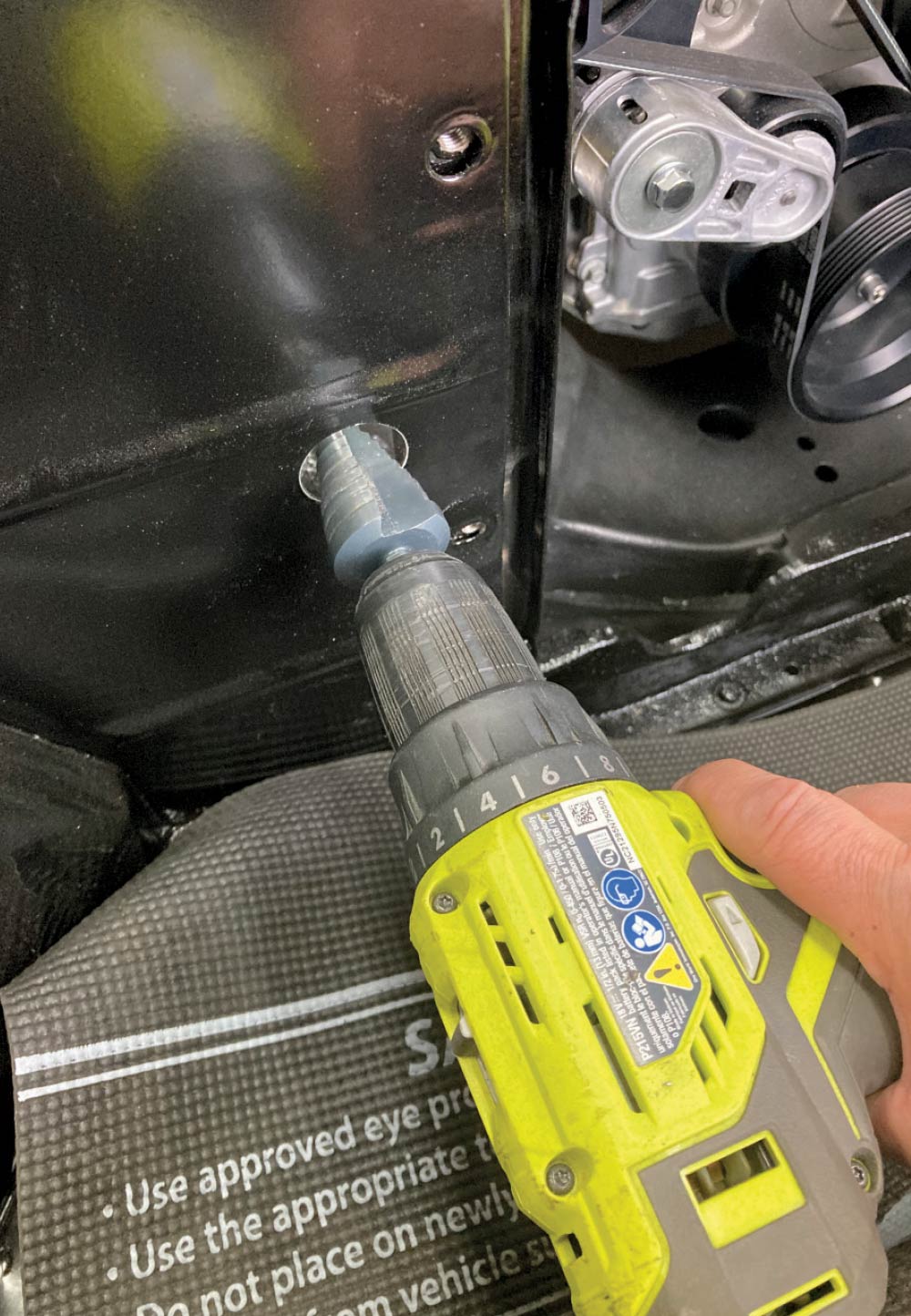 Step drill bit used to enlarge firewall hole for AC lines