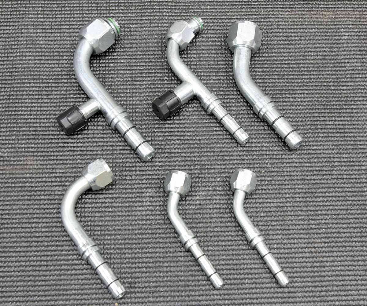 Various AC hose fittings and adapters laid out