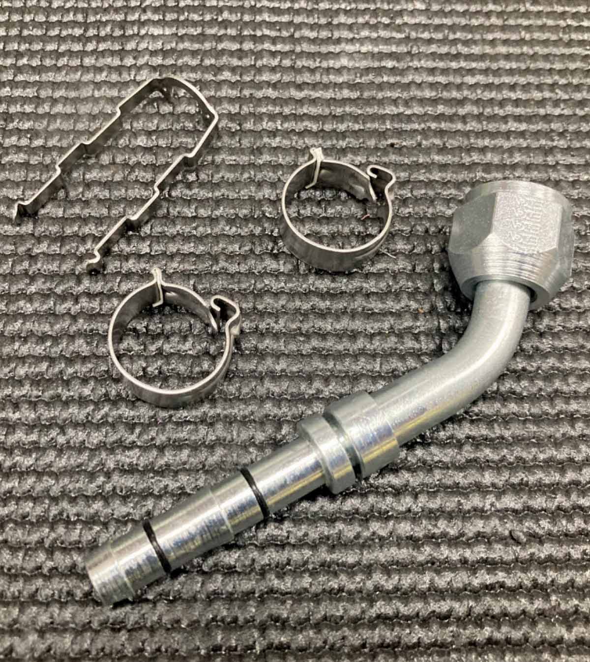 AC fitting with clamps and retaining clip