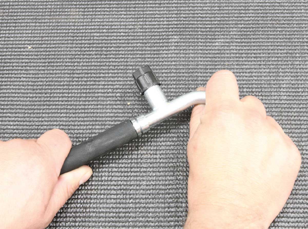 Hand-fitting a hose onto an AC fitting