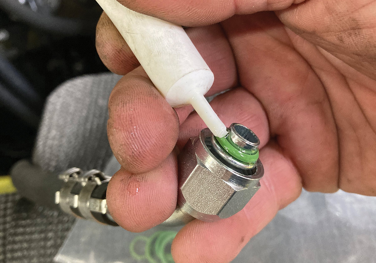 Applying lubricant to an AC fitting O-ring for proper sealing