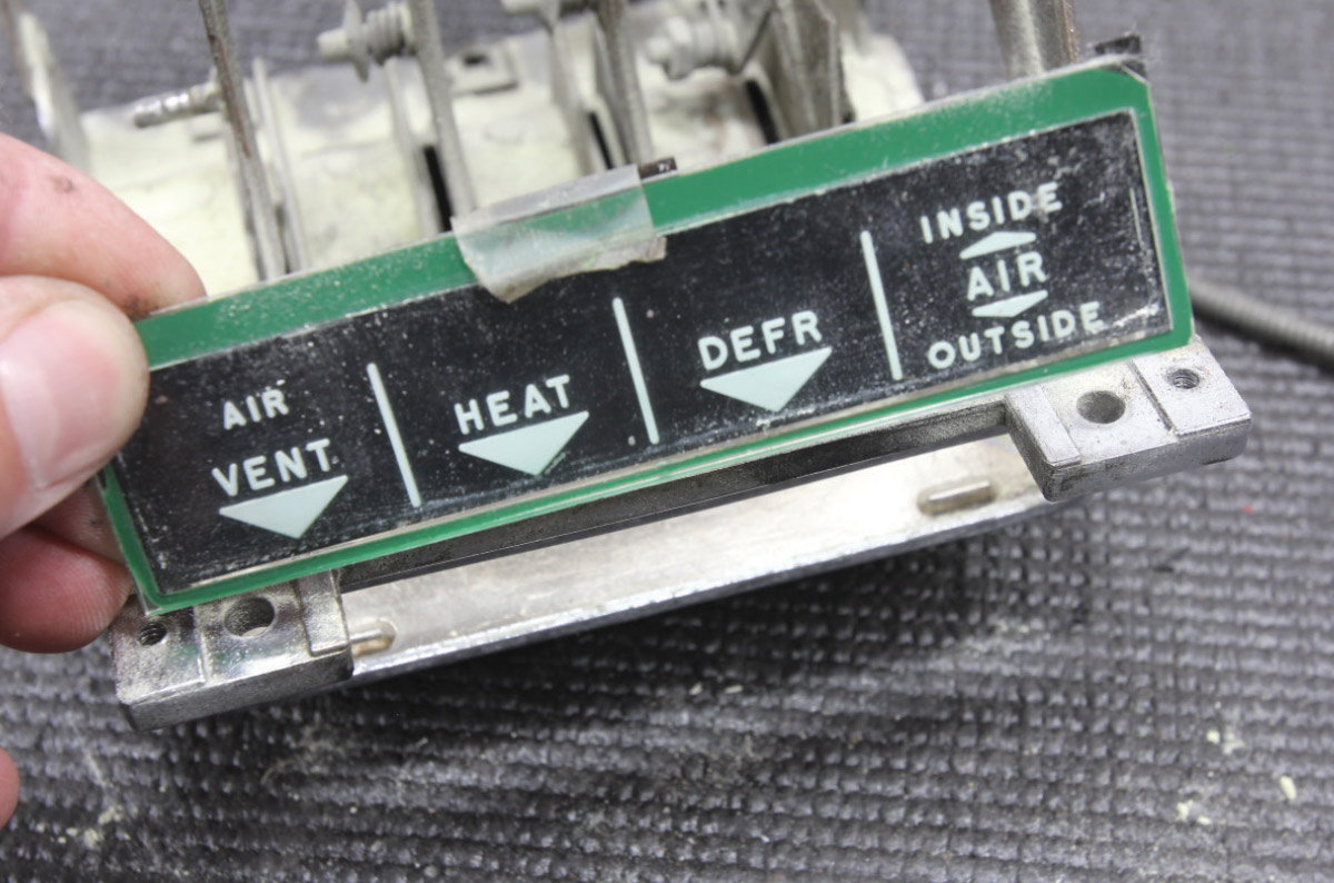Removing the original control panel label for a new overlay