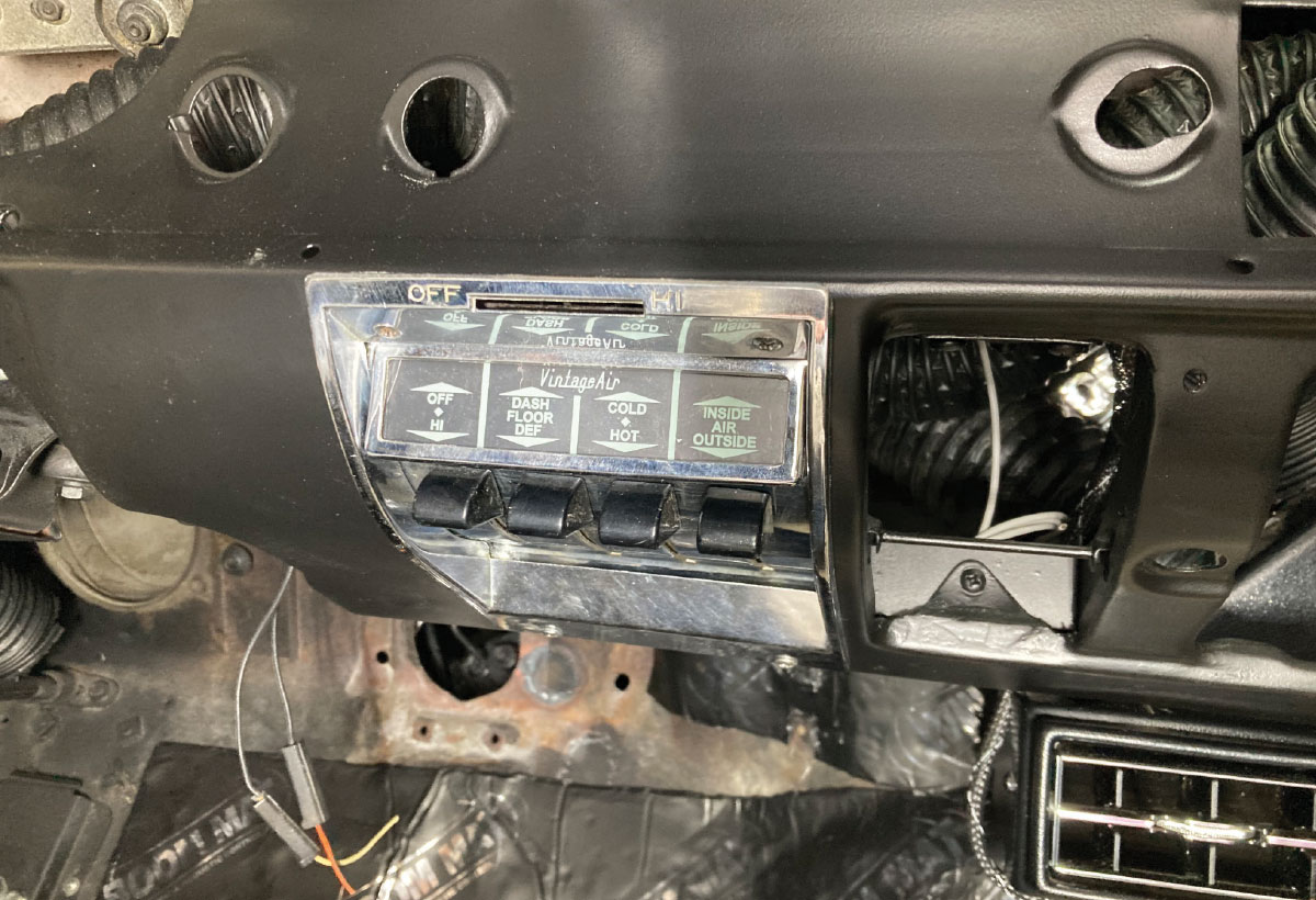 Vintage Air control panel installed in the dashboard, with additional vent and wiring modifications in progress