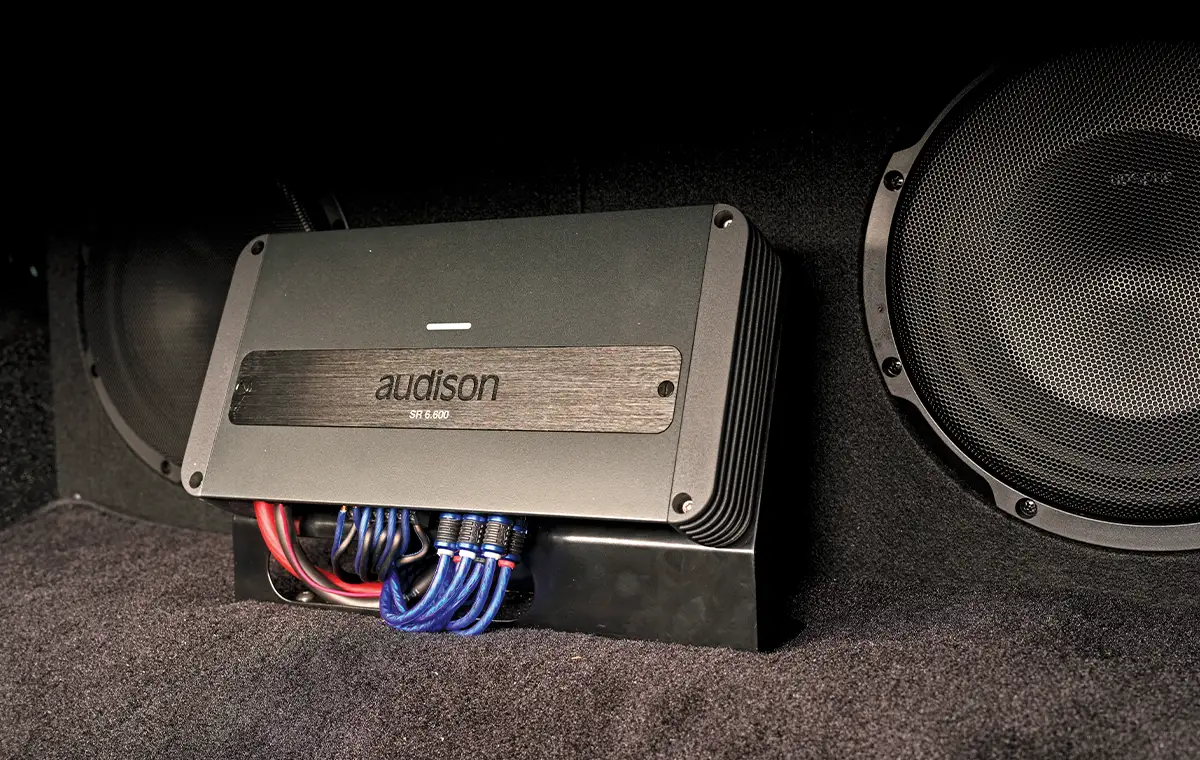 1987 Monte Carlo trunk-mounted Audison SR 6.600 amp with dual subwoofer setup