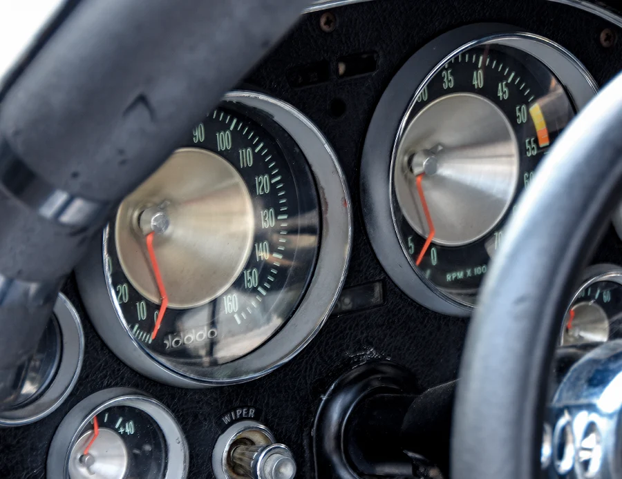 1963 Corvette dashboard with factory-style gauges, aftermarket tach, and switchgear for drag racing use