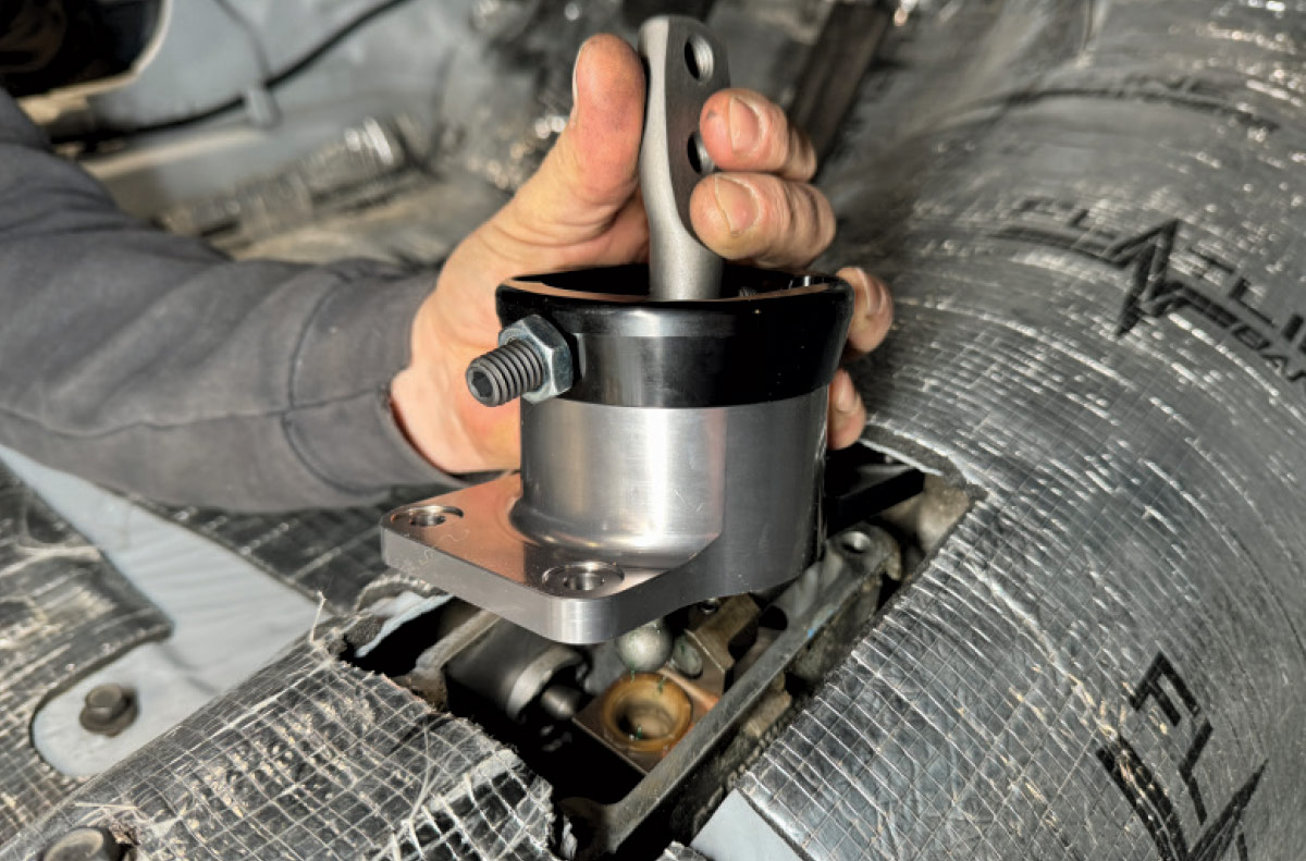 1971 Camaro billet short-throw shifter being placed on TREMEC transmission