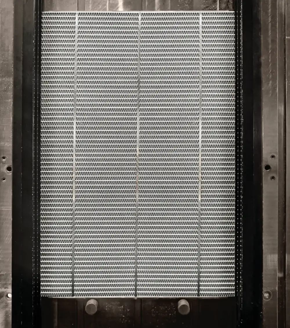precision aluminum radiator core assembly in a manufacturing press