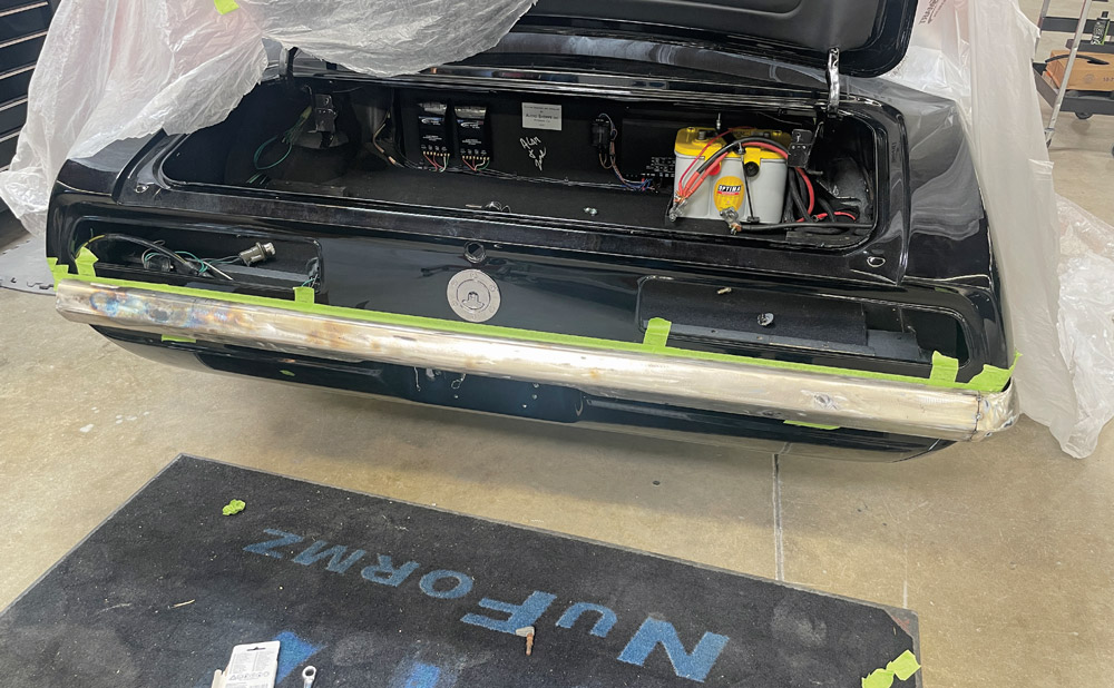 1969 Camaro rear bumper test-fitted in raw metal finish, taped for mock-up alignment
