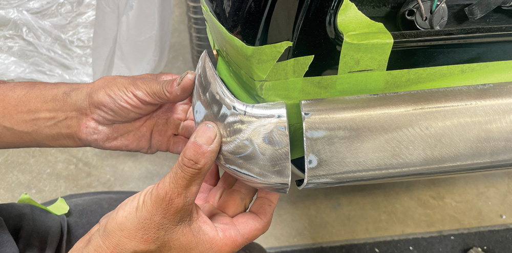 1969 Camaro rear bumper corner held in place to verify gap and profile consistency