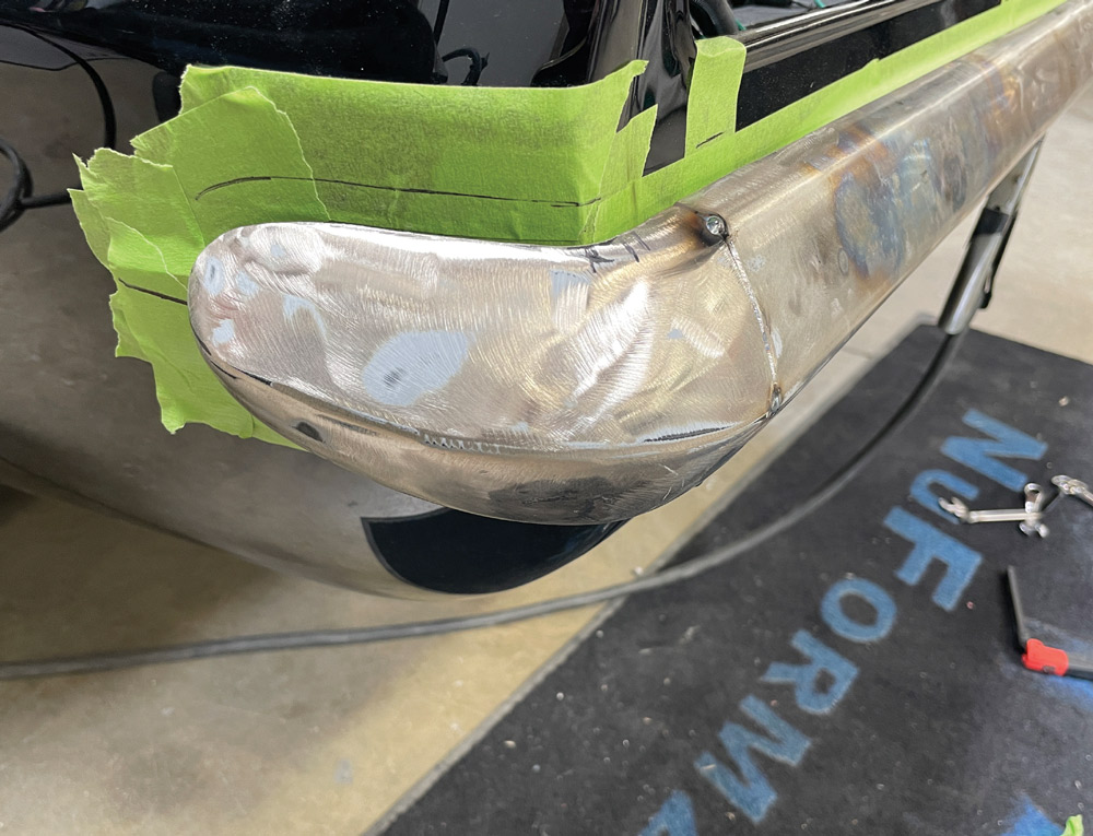 1969 Camaro rear bumper tack-welded and contoured to body lines with guide tape for shaping