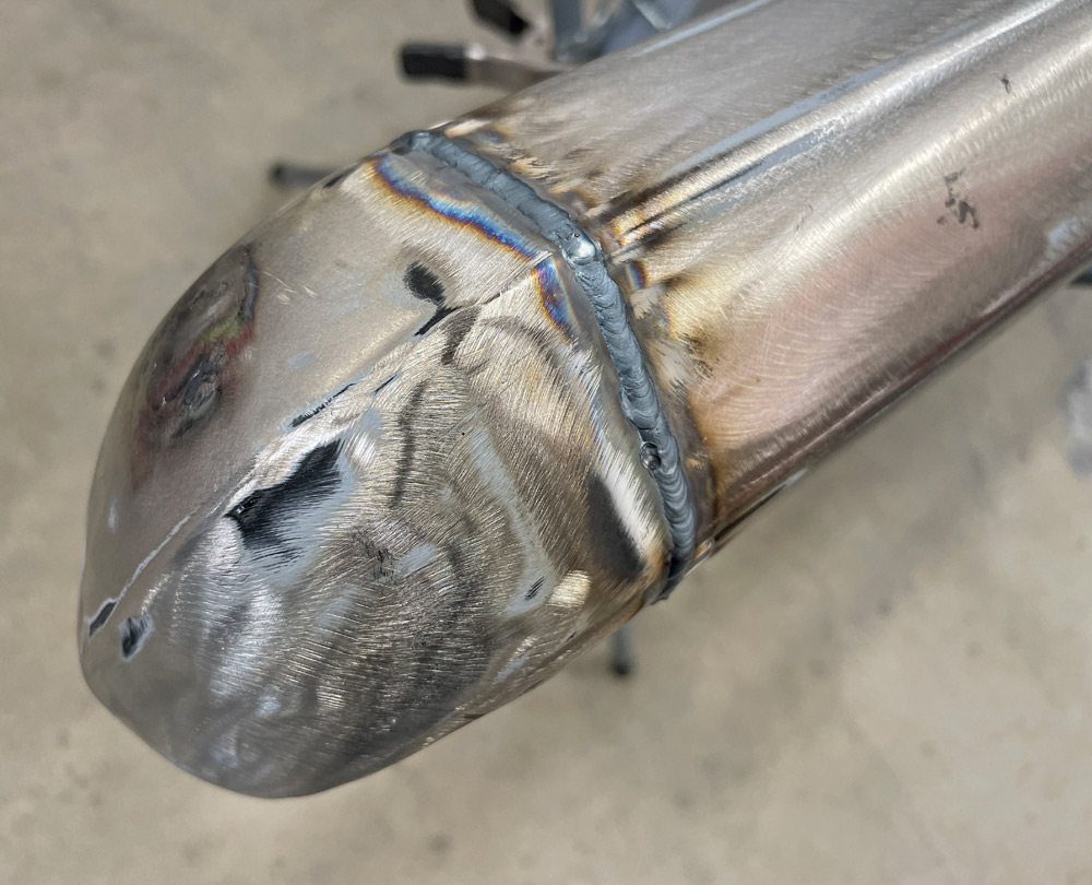 1969 Camaro bumper corner TIG welded and heat-discolored, ready for post-weld finishing