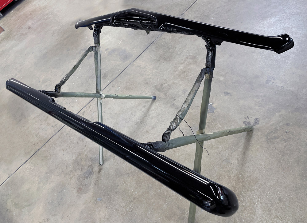 1969 Camaro bumpers fully painted gloss black and staged for final installation