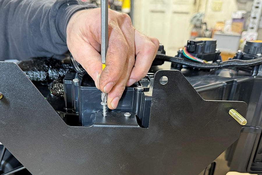 Follow by adding (two) 1/4-20 full-threaded studs halfway into the mounting holes on either side of the evaporator firewall bracket. Continue by mounting the bracket to the evaporator module using the provided (four) 5/8-inch screws