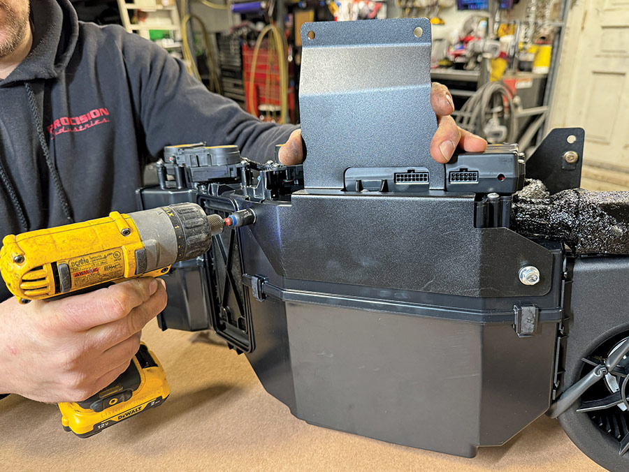 Now install the evaporator module cowl bracket in place using (two) 1/4-20 x 1-inch serrated flange bolts into the well nuts