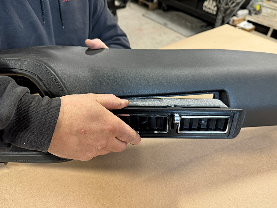 Begin the assembly of the new OER (Original Equipment Reproduction) dash from Classic Industries starting with the fitment of the center dash louvered vent assembly for air conditioning topped by a foam strip supplied by Vintage Air
