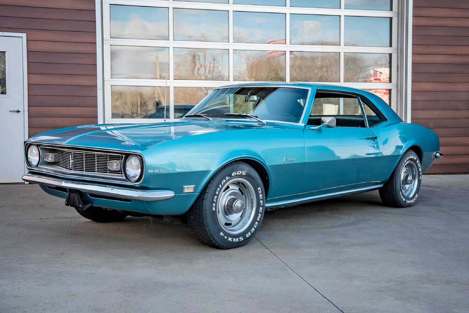 1968 Chevy Camaro in LeMans Blue with 350 badging and rally wheels sits in original condition