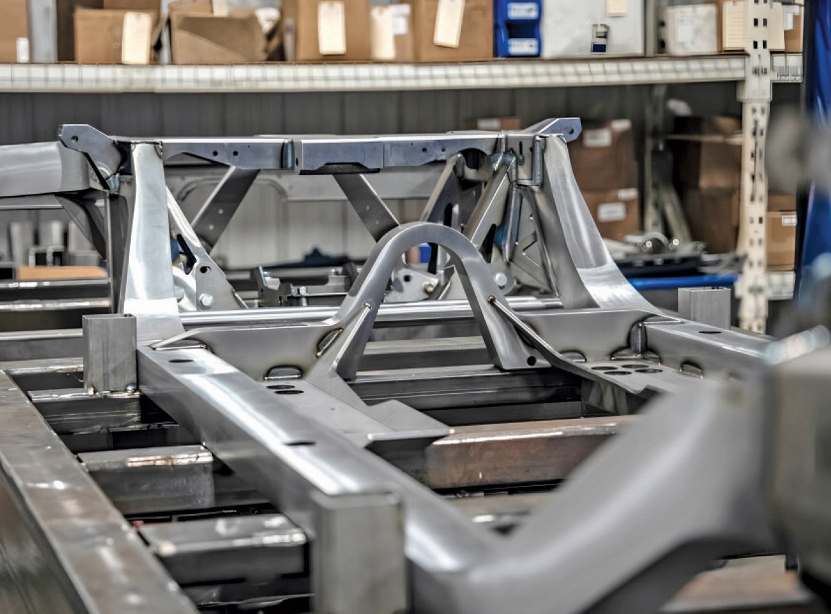 1968 Camaro full-frame chassis mockup under construction on a fixture table