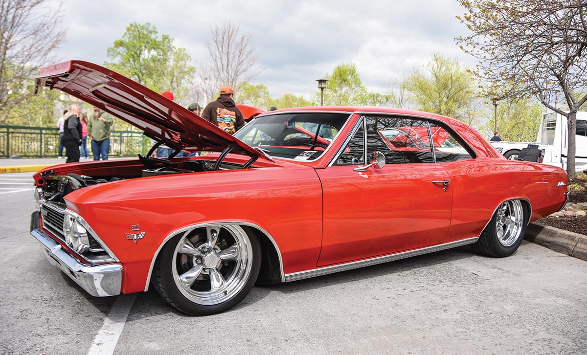 red car parked with hood open