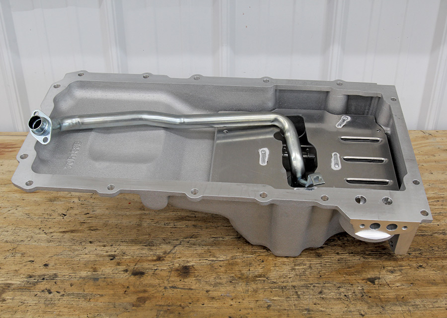 A new cast aluminum aftermarket oil pan designed for an LS engine, featuring an internal baffle system and an integrated oil pickup tube.