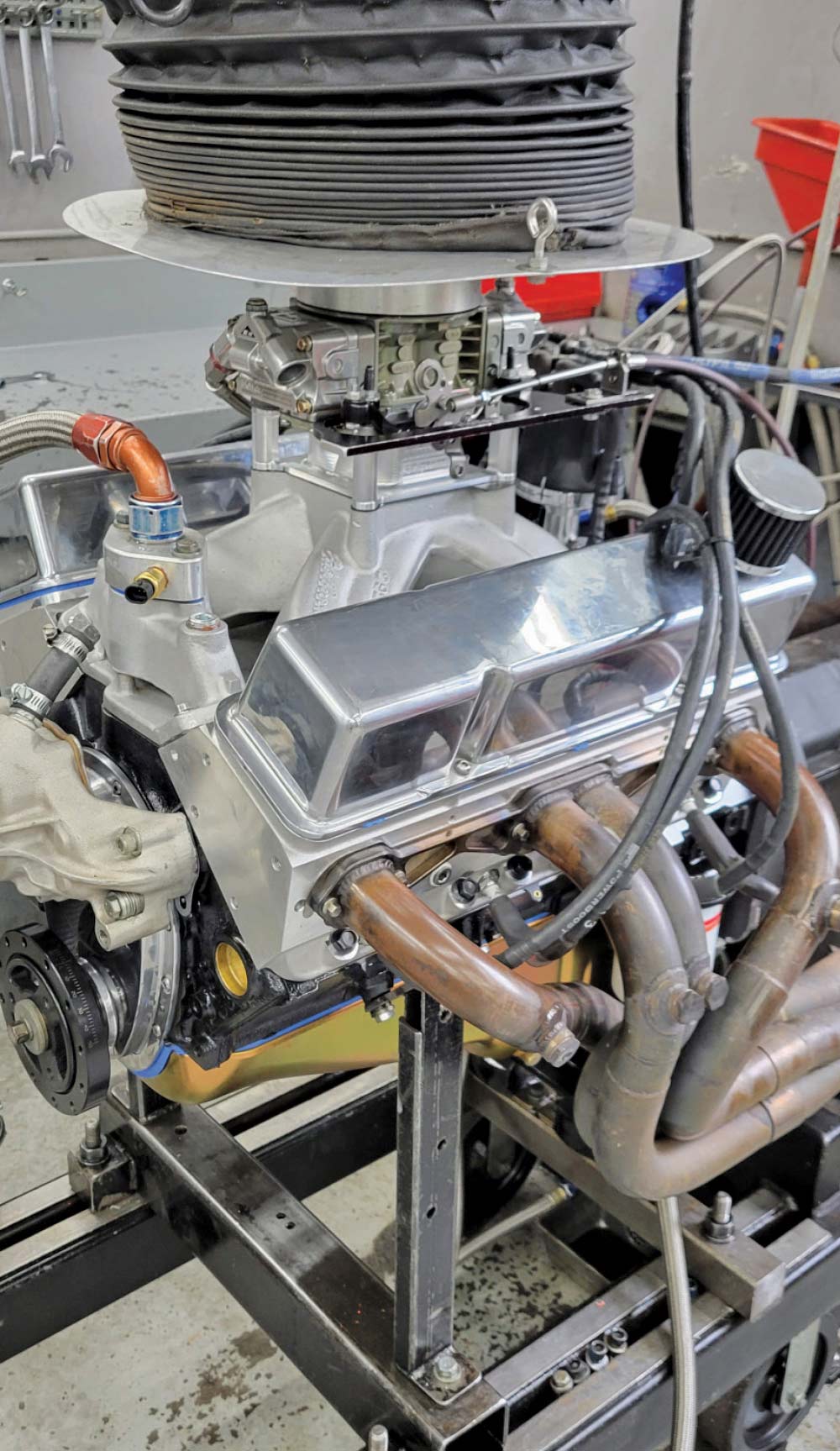 A fully assembled engine is shown from a side view, mounted on a test stand.