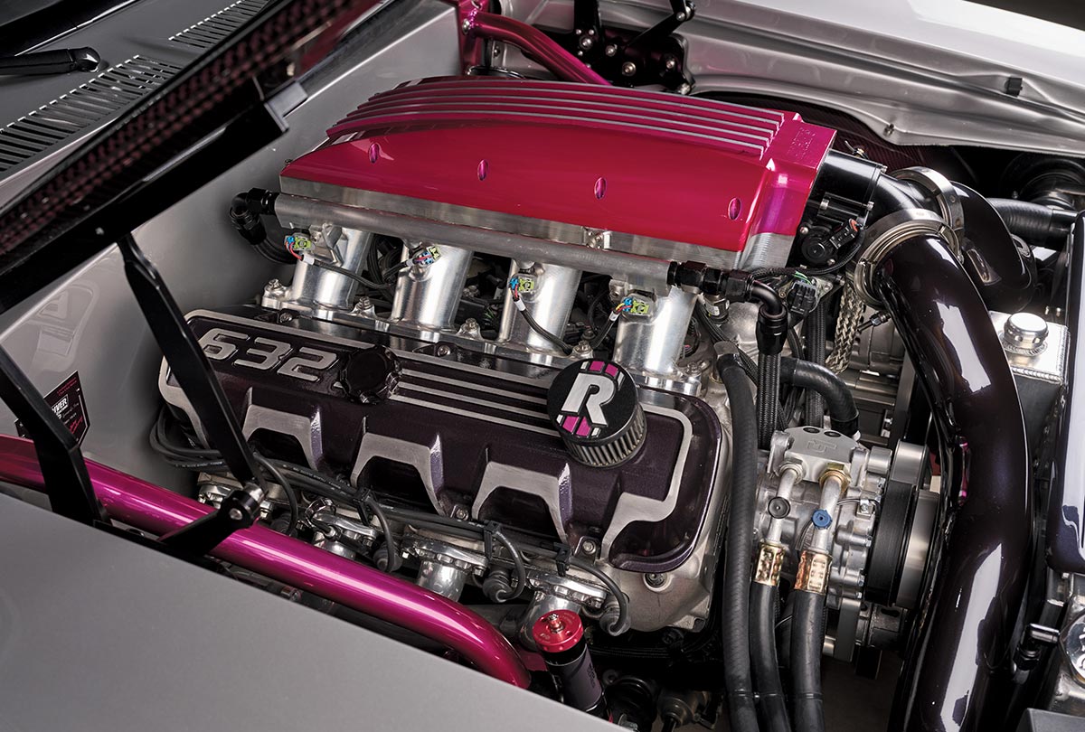 close-up view of a limited-edition 1969 Nova custom engine with a large pink intake manifold and black components