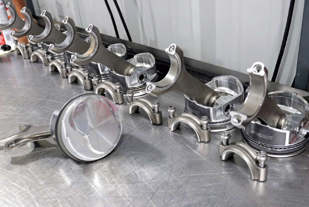 Manley forged pistons and rods laid out for high-performance engine assembly