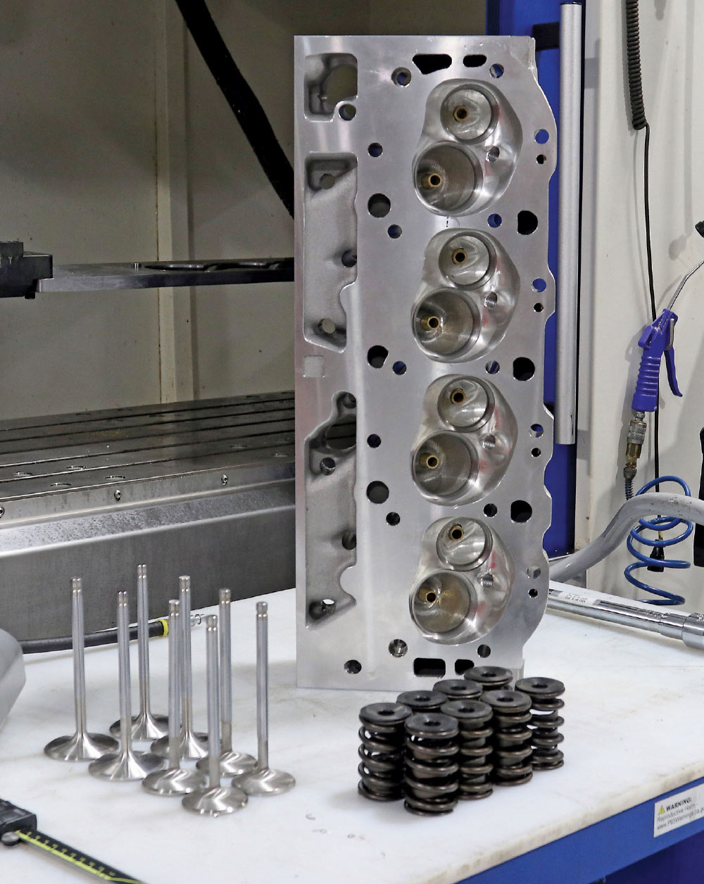 Bare aluminum cylinder head staged with valves and springs for high-performance valvetrain assembly