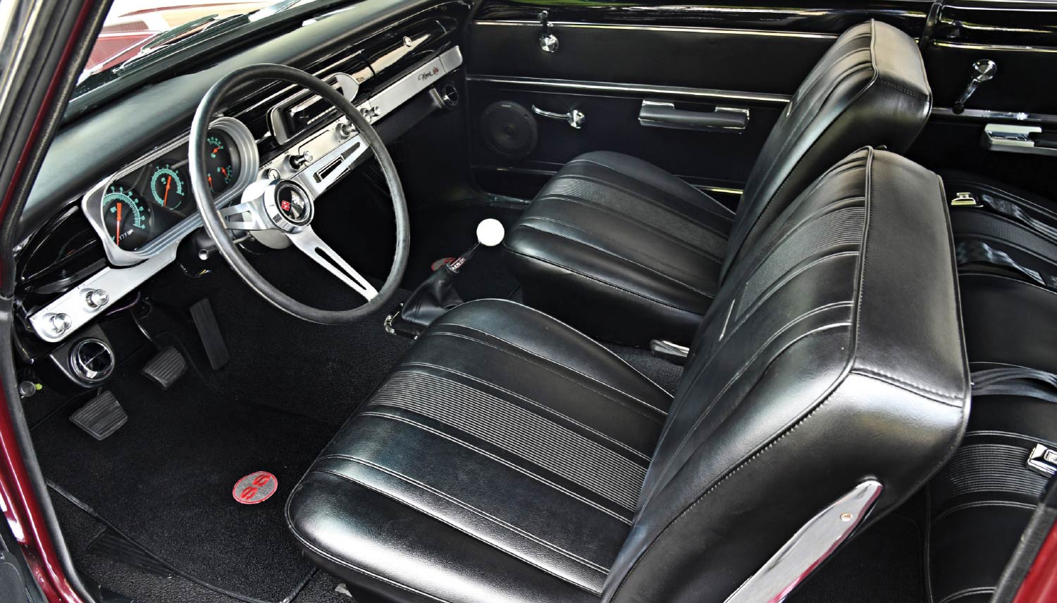 1965 Chevy Nova bucket seats black interior with floor shifter and retro dash trim