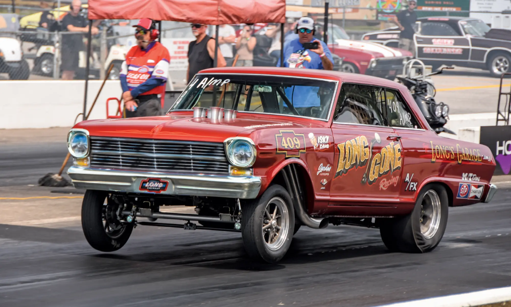 1966 Chevrolet Nova AFX drag car “Long Gone” launches hard with fenderwell headers and 409 callout