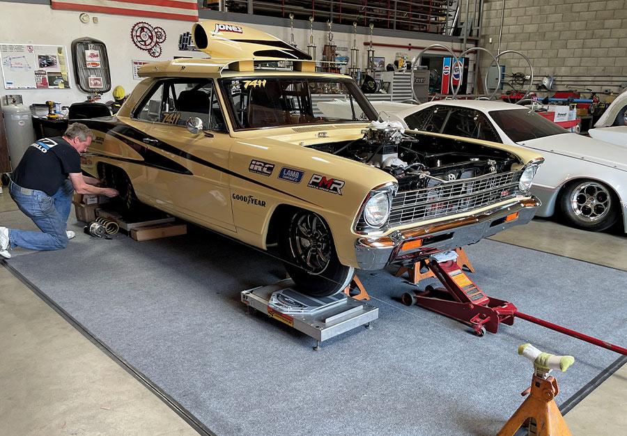 1966 nova drag car on scales during suspension alignment in race shop