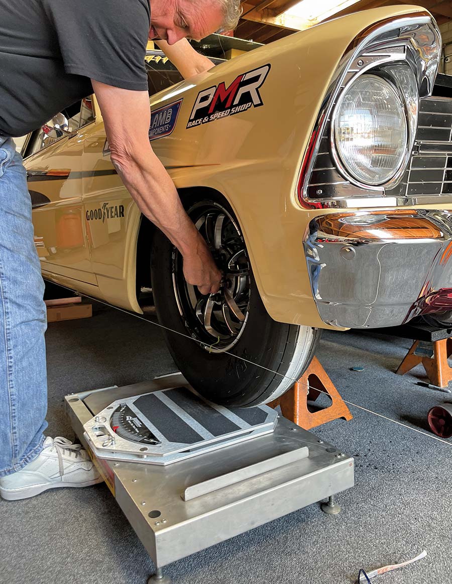 checking toe on 1966 nova front wheel using string and digital scale