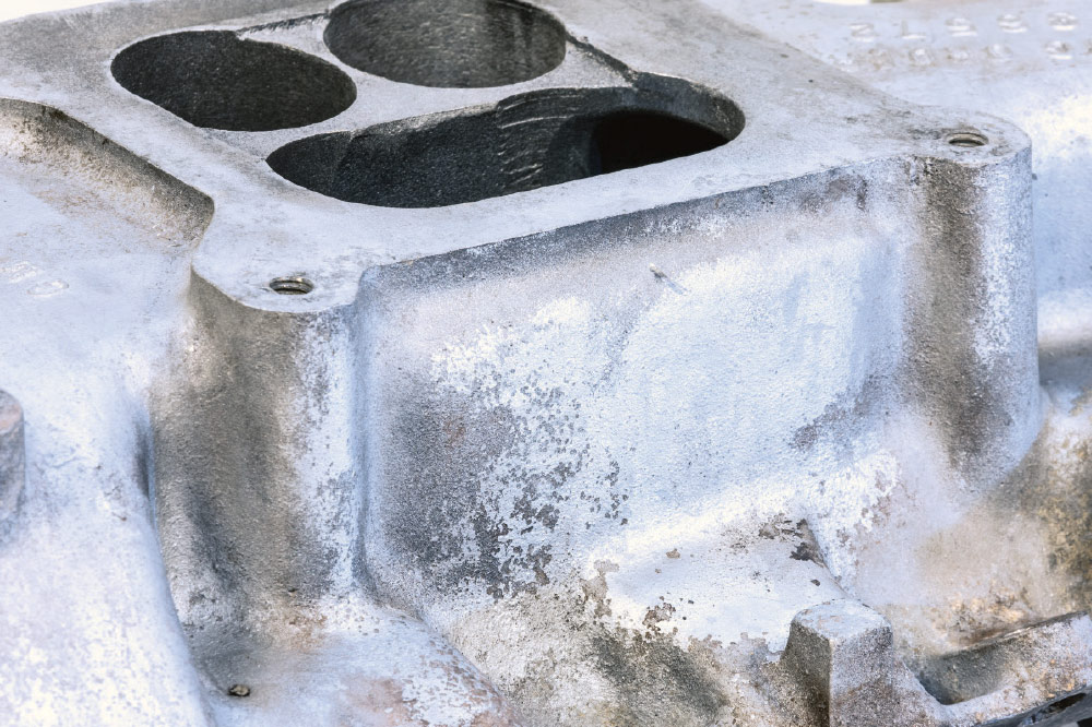 close-up of oxidized aluminum and pitting from age