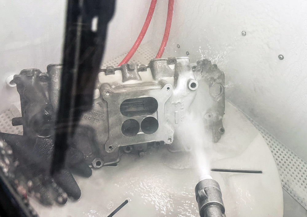 vapor honing in progress — blasting intake manifold