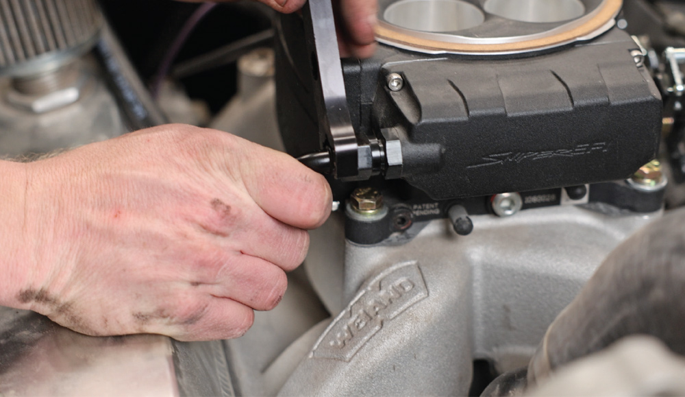 Tightening AN fitting on Sniper EFI fuel inlet using aluminum wrench