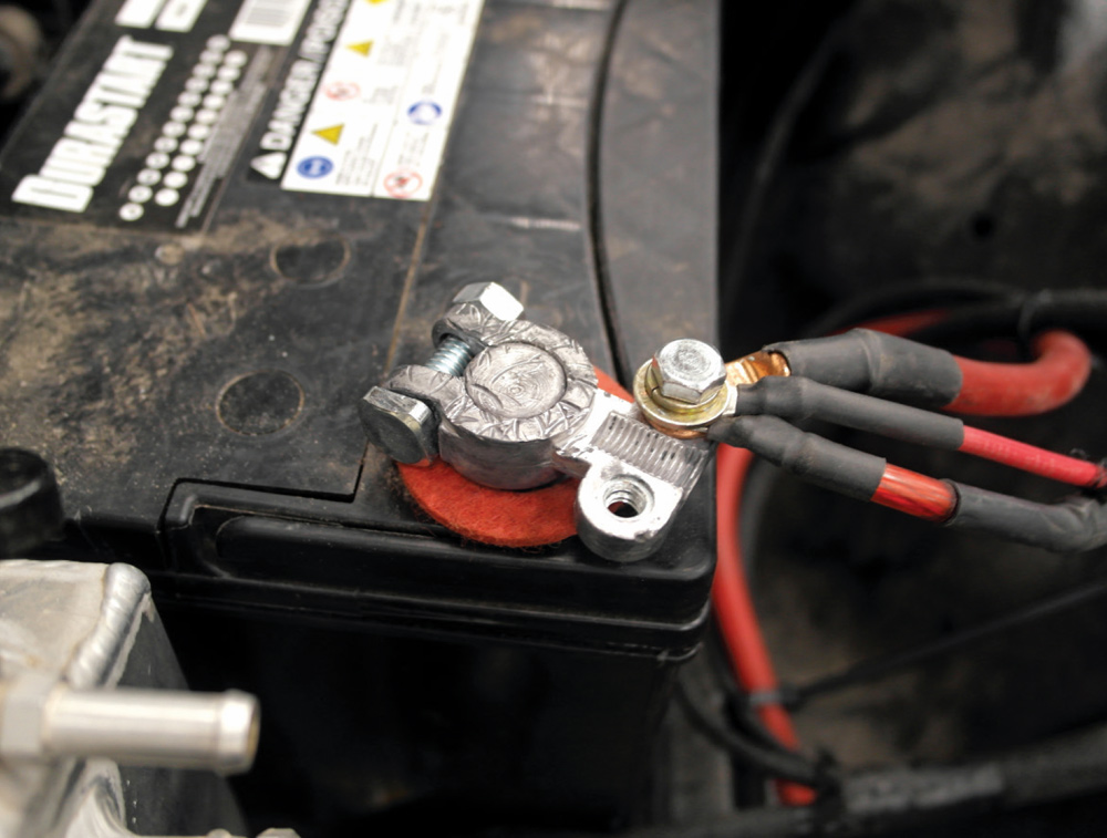 Power and ground connections secured to battery terminal with heat-shrink protection