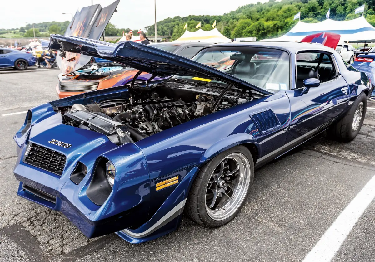 1979 Camaro Z28 blue with silver stripes blacked-out headlight buckets Pro Touring build