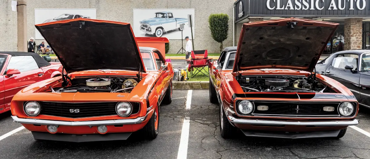 1969 Camaro SS pair orange and hugger orange side-by-side chrome rally wheels