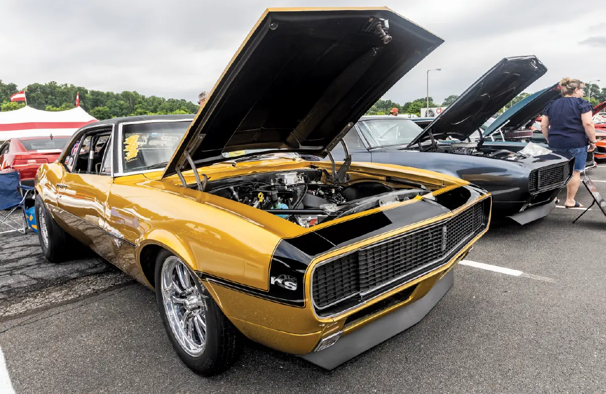 1967 Camaro RS gold with black stripe drag slicks race-ready stance
