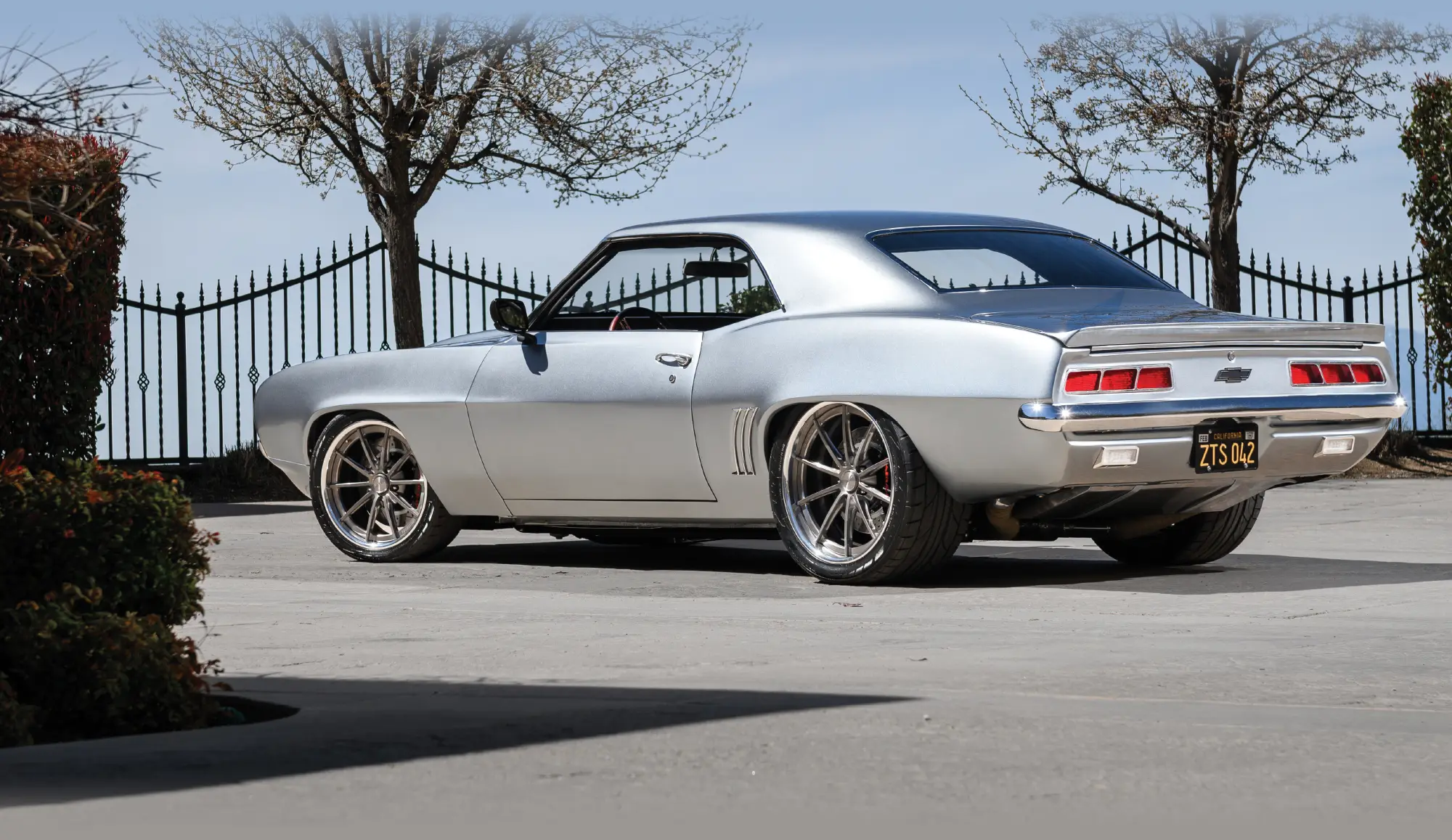 Rear quarter view of a silver 1969 Chevrolet Camaro.