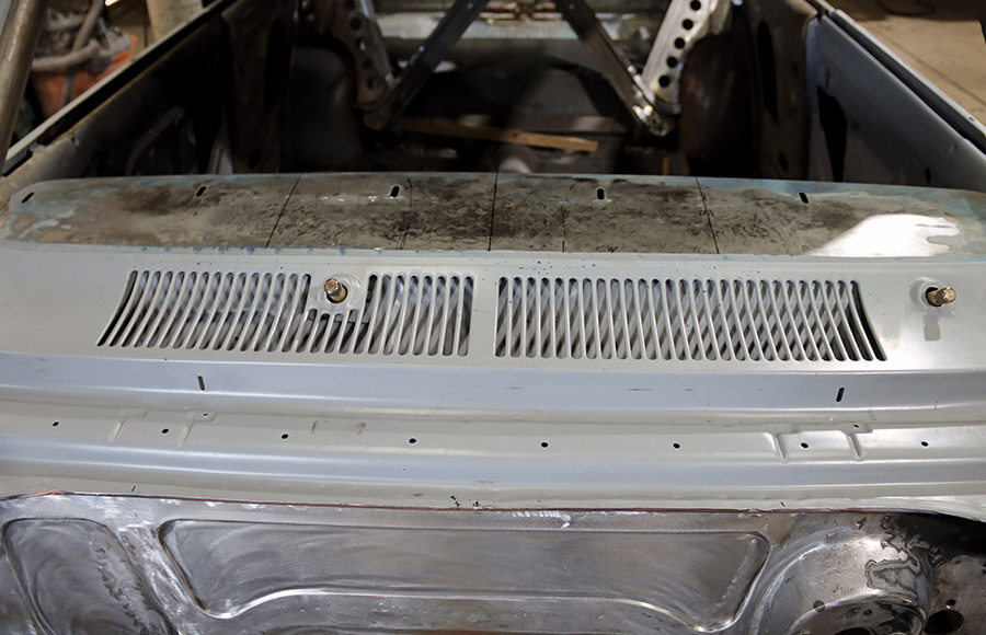 1967 Nova factory cowl vent before modification with original slotted grille and wiper post visible