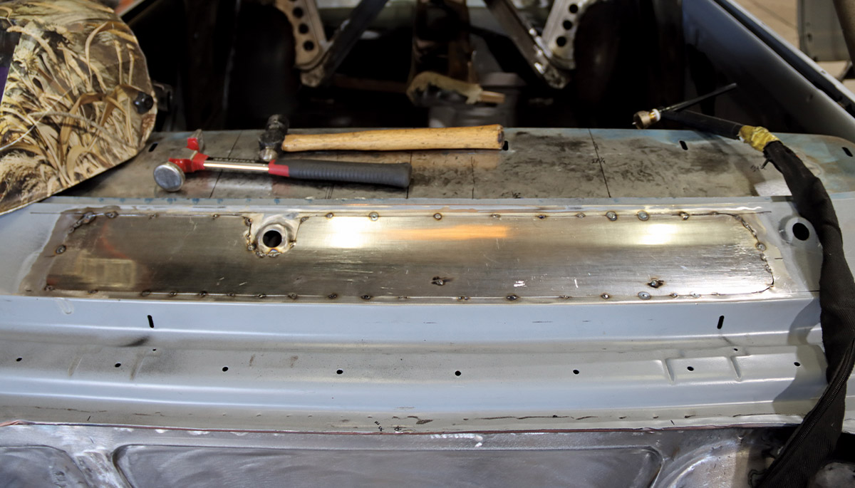 1967 Nova cowl patch tacked in place with TIG torch and scribe used for tight seam alignment
