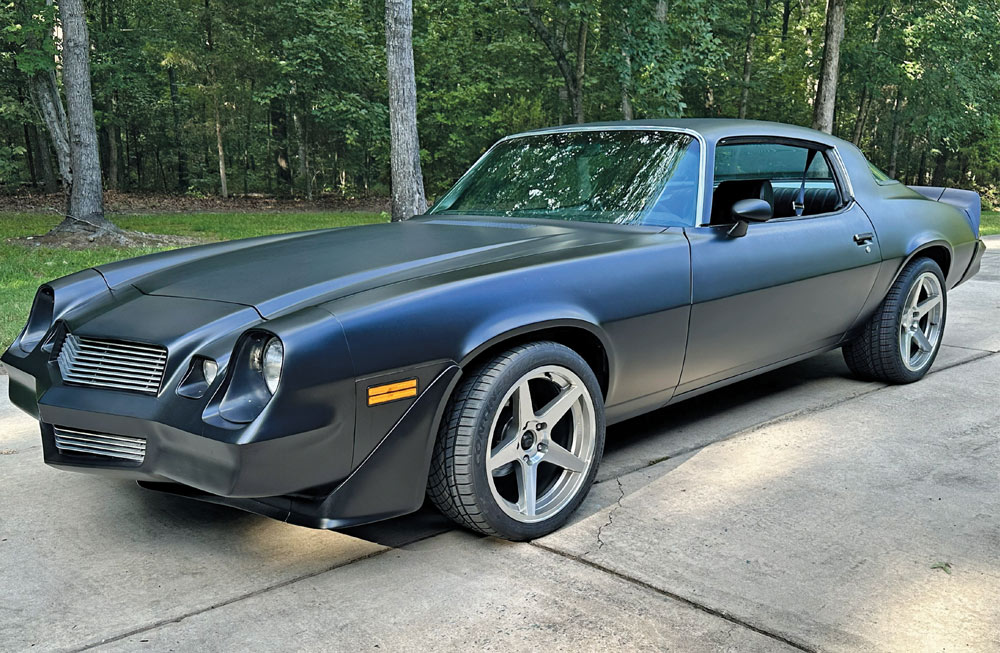1978 camaro matte black with aftermarket wheels parked on driveway