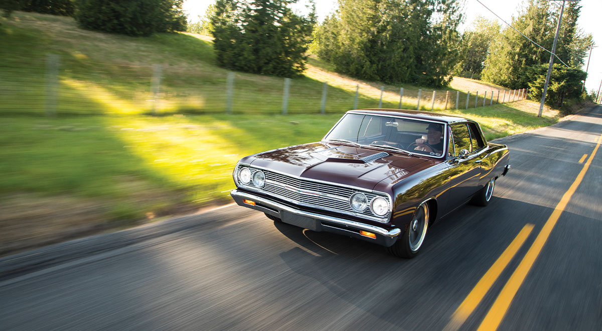 1965 Chevrolet Chevelle cruising highway motion shot classic muscle car