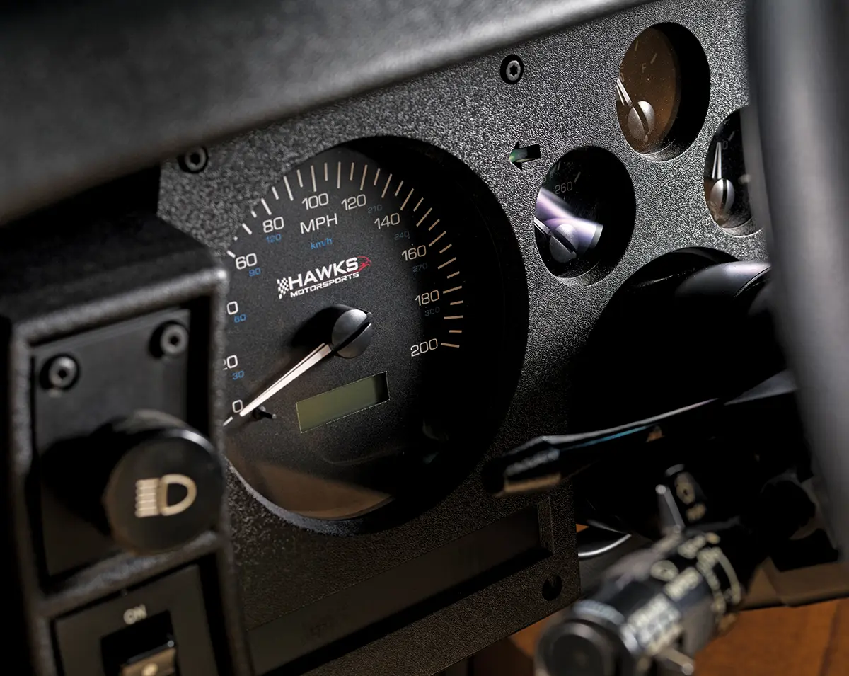 Close-up of a custom Hawks Motorsports 200 MPH speedometer and auxiliary gauges in a modified Chevrolet Camaro IROC-Z.