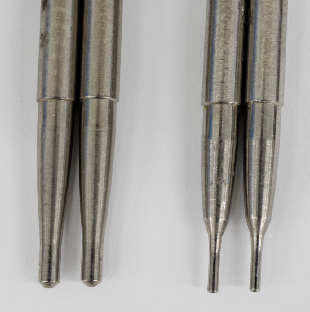Extreme macro view comparing two sets of carburetor metering rods, highlighting the subtle differences in the tapered tips that control fuel flow.